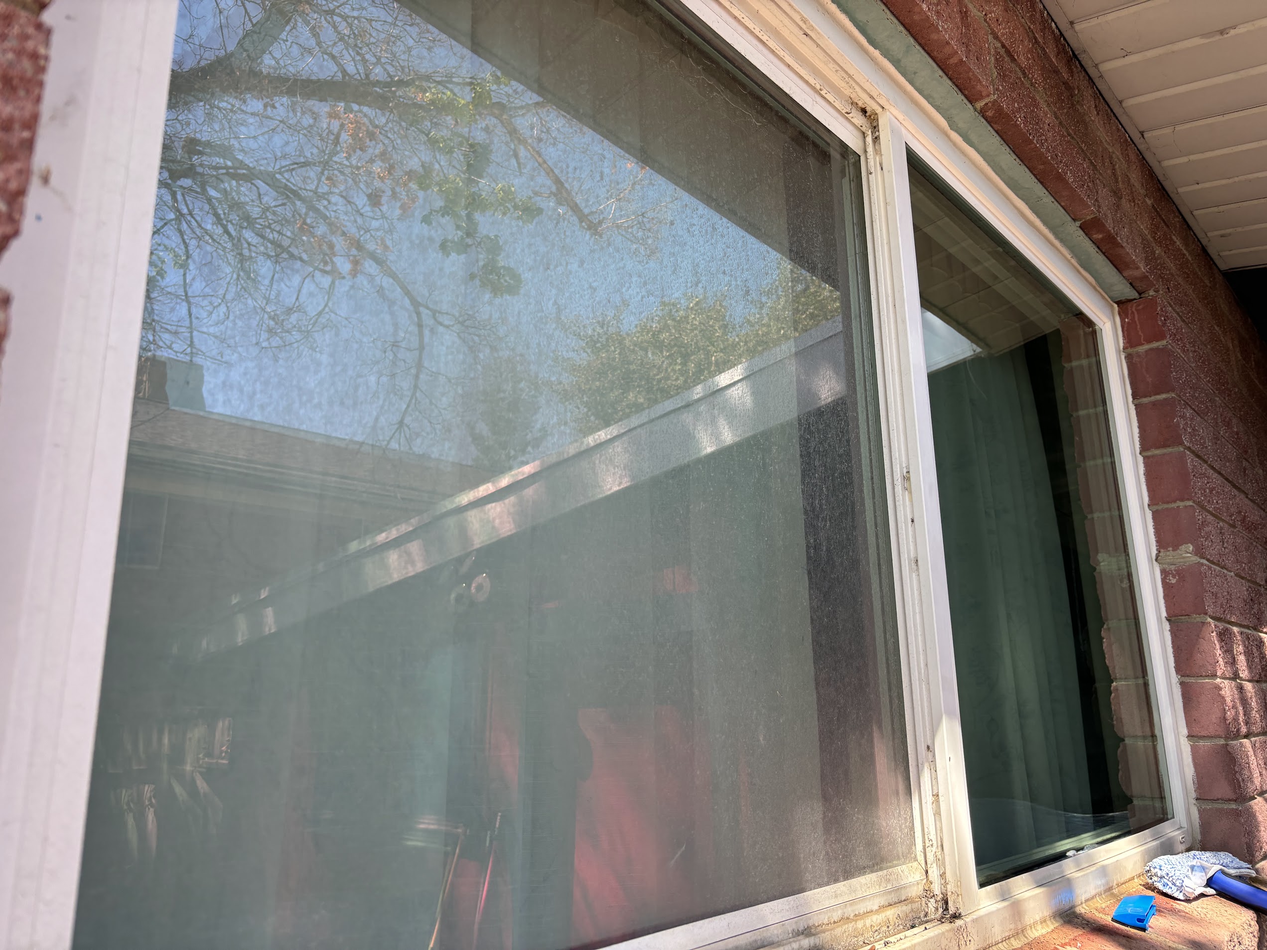 A hazy, streaked window before cleaning
